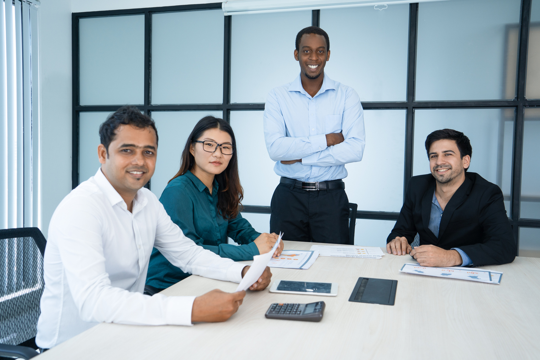 Cheerful Black Managing Director and His Team in Modern Office